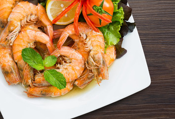 Shrimp boiled with honey and salt  in white dish on dark table