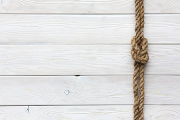 White wooden background, ship rope, sea knot, ship deck