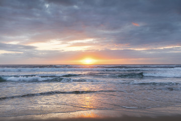 Fototapeta na wymiar Cloudy and colourful beach sunrse on the Gold Coast