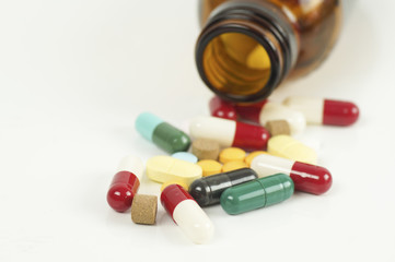 capsule and bottle on white background