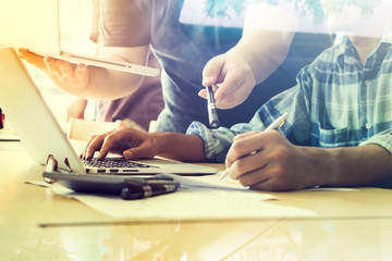 Team work concept,team meeting,Business meeting time. Photo young account managers crew working with new startup project. Notebook on wood table. Idea presentation,Selective focus,Vintage tone