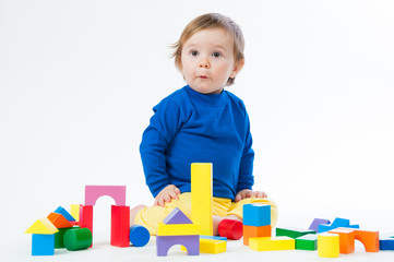 Little child playing with dices isolated on white background