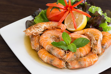 Shrimp boiled with honey and salt  in white dish on dark table