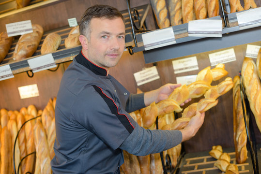 Baker holding baguettes