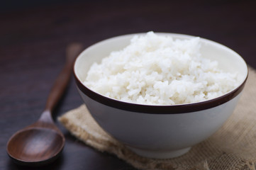 Thai rice in bowl with wooden spoon on table