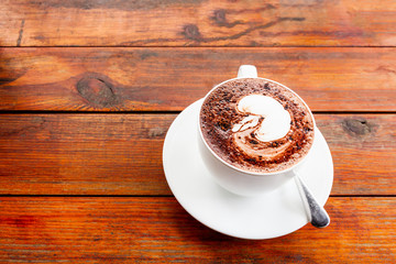 hot chocolate cup on wood table in cafe.