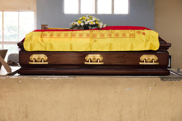 A brown Casket at a traditional Chinese funeral services