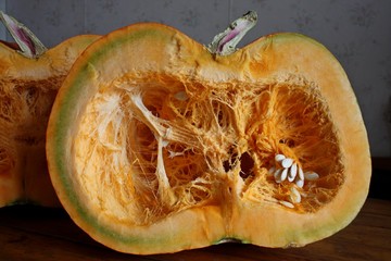 Orange pumpkin half, vegetarian food background