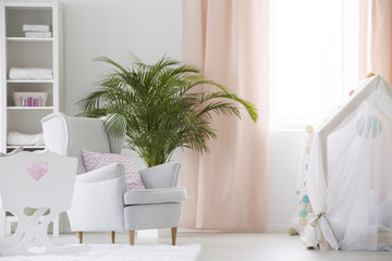 Armchair and crib in baby room