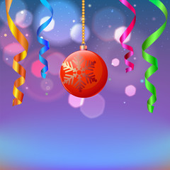New year composition with serpentine and Christmas ball on blurred background