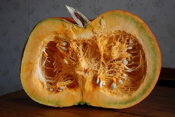 Half of the huge orange garden vegetable pumpkin close up