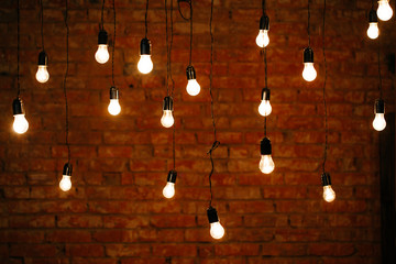 Light bulbs in interior over dark wall