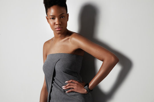 serious black woman with short haircut in studio shoot.