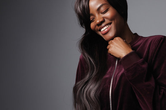 pretty black woman with long shiny hair in studio shoot