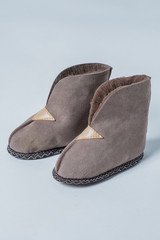 Natural slippers for a home wool on a white background