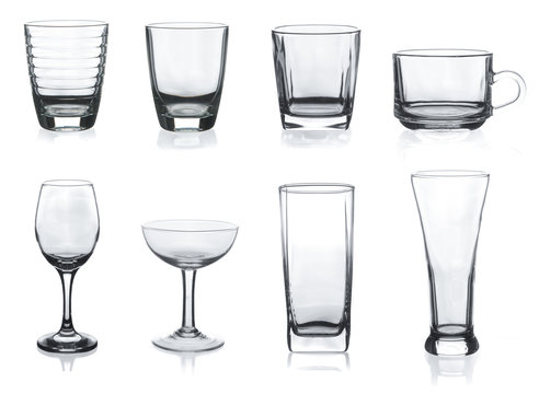 Collection of empty glasses and mugs on white background
