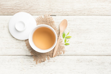Cup of tea and tea leaves on wooden,top view