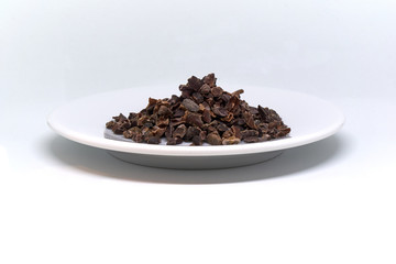 cacao nibs on a plate isolated