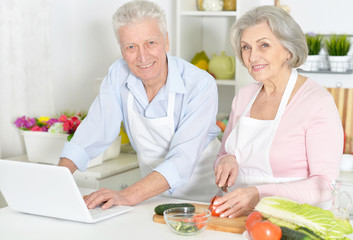 Beautiful elderly couple preparing breakfast