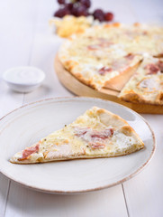 Pizza with chicken on a wooden board