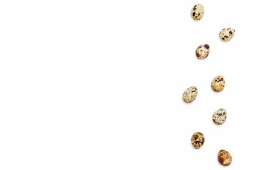 a few Easter quail eggs on the right on a white background.