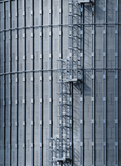 Metal ladder on grain elevator tower as abstract industrial background