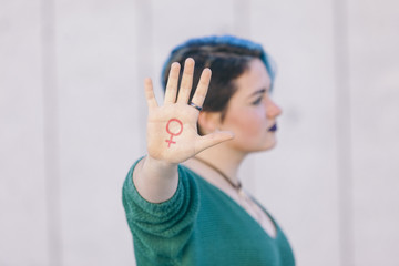 symbol of woman feminism isolated on a hand of a teenager