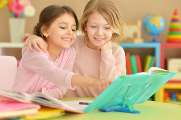 Fototapeta premium Two girls with their homework