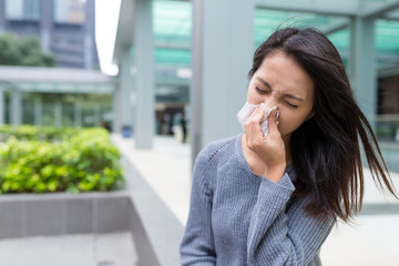 Fototapeta premium Woman feeling sick and sneezing