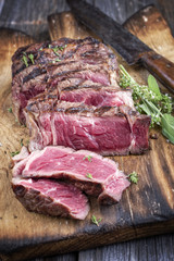 Barbecue Rib Eye Steak sliced on a Cutting Board