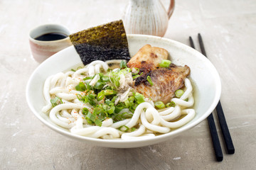 Trafitional Japanese Udon Fish Soup as close-up in a Bowl
