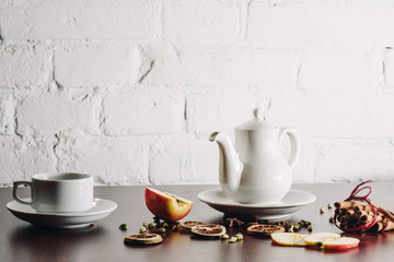 Tea cups with teapot on old wooden table