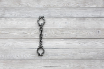 Shackles of slaves, white wooden background