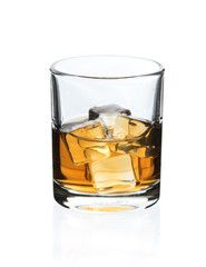 Glass of whisky with ice on a white