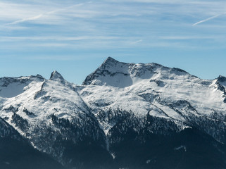 Beautiful landscape of Italian Alp mountains covered in snow with blue sky