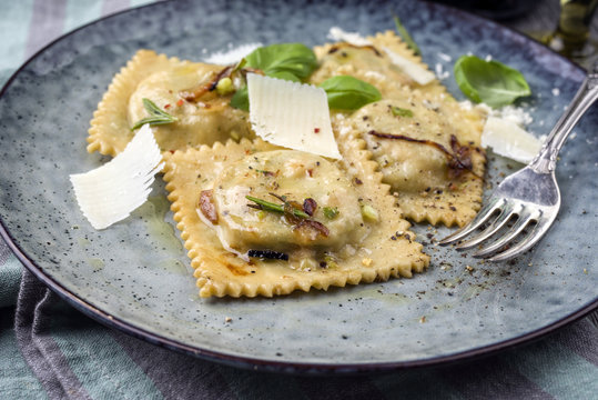 Traditional Italian Ravioli with Parmesan as close-up on a Plate - Powered by Adobe