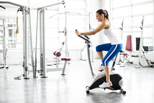 Aerobics spinning woman exercise workout at bikes gym
