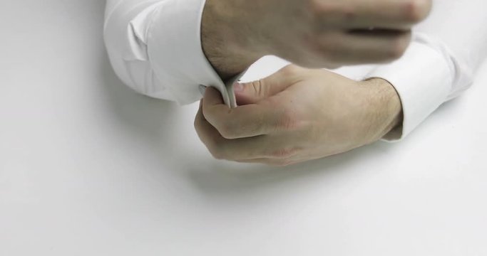 4K Close-up of man's hands removed cufflinks on his white shirt