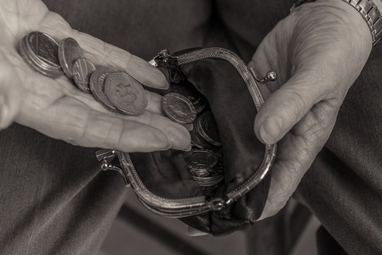 British Pensioner Putting Money In Purse. Cost Of Living.