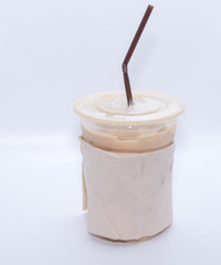 Iced coffee with straw in plastic cup on white background