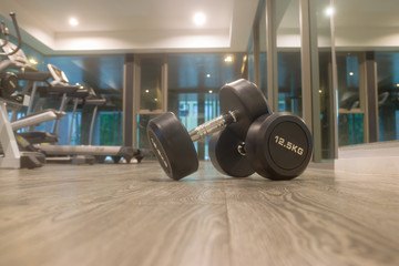 Fototapeta na wymiar weight body building with Sports dumbbles,Dumbbells in the fitness room.