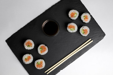 Sushi of norimaki with trout and cucumber on slate plate