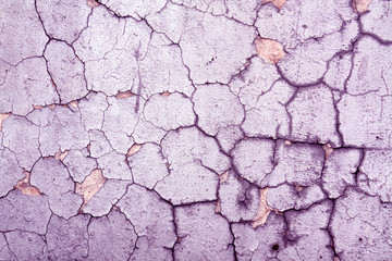 Cracked violet cement wall texture.
