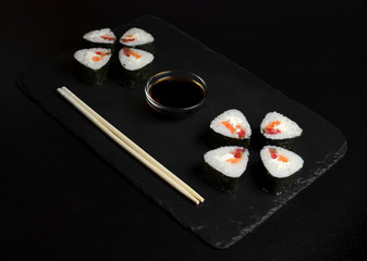 Sushi with tuna on slate plate with chopsticks