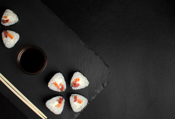 Sushi with tuna on slate plate with chopsticks