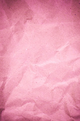 Pink crumpled recycle paper background.