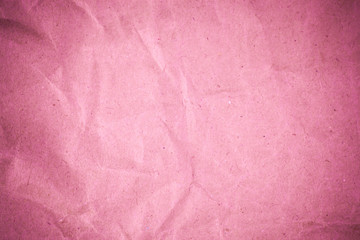 Pink crumpled recycle paper background.