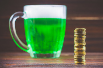 A mug of green beer on the table. Clover leaves. Chest of gold, coins pile. St.Patrick 's Day.