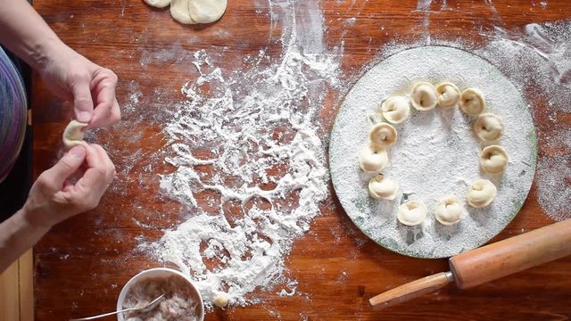 Elderly woman make homemade dumpling, hd video, top view