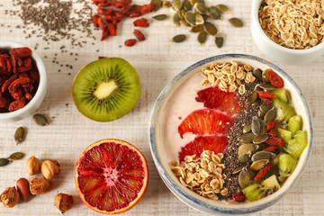 Superfoods smoothies bowl with chia seeds, oats, goji berry and fruit. Overhead, top view, flat lay.